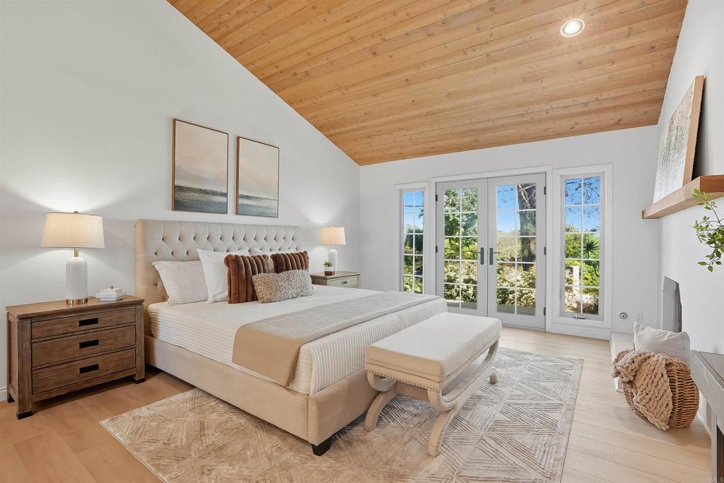 2206 Running Spring Place Encinitas, CA 92024 - Photo 23 of 44 a bedroom with a bed and a couch