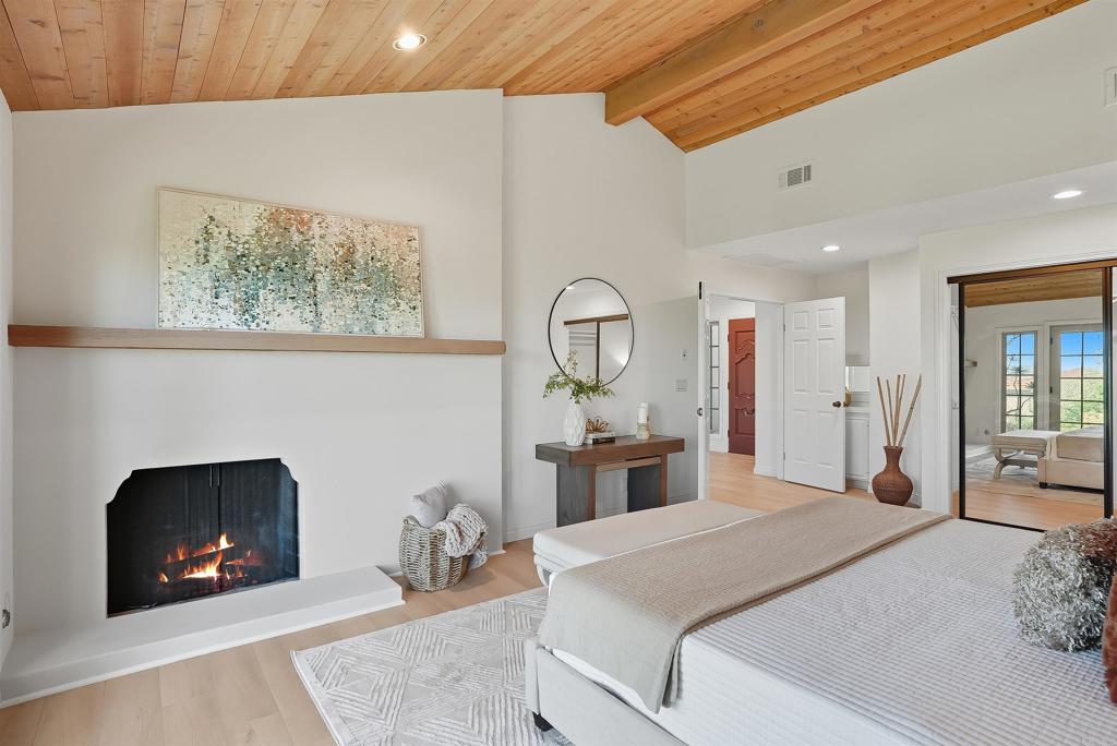2206 Running Spring Place Encinitas, CA 92024 - Photo 24 of 44 a bedroom with a bed and a fireplace