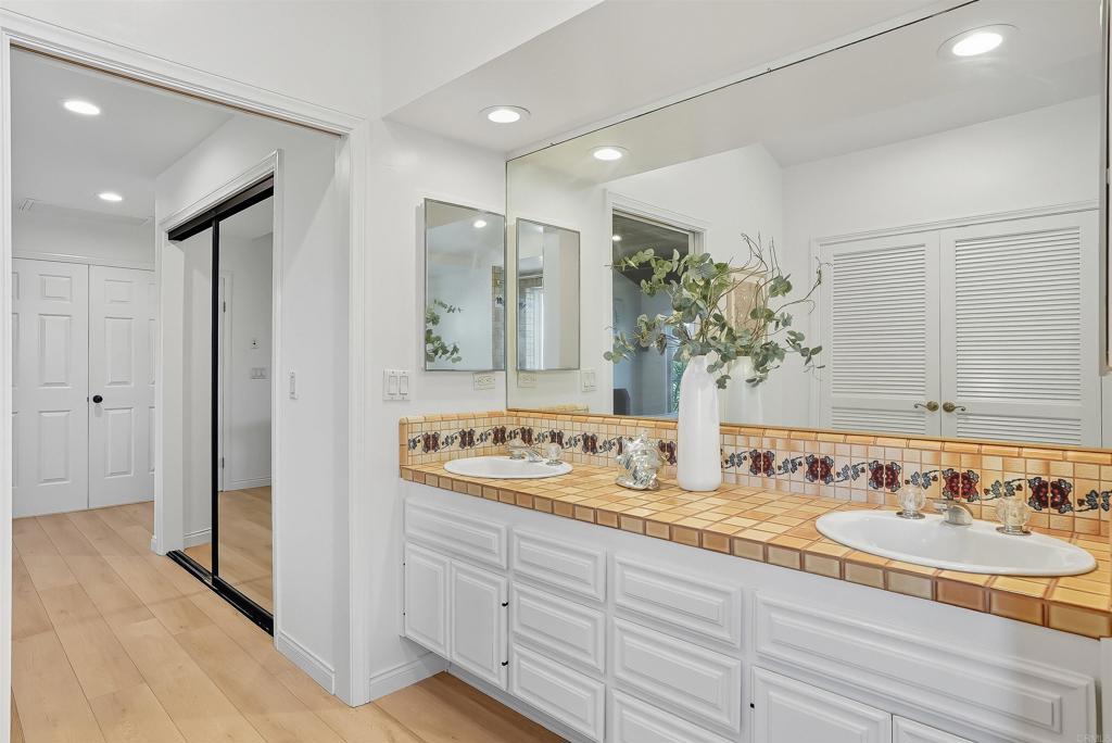 2206 Running Spring Place Encinitas, CA 92024 - Photo 27 of 44 a bathroom with a double vanity sink and a mirror