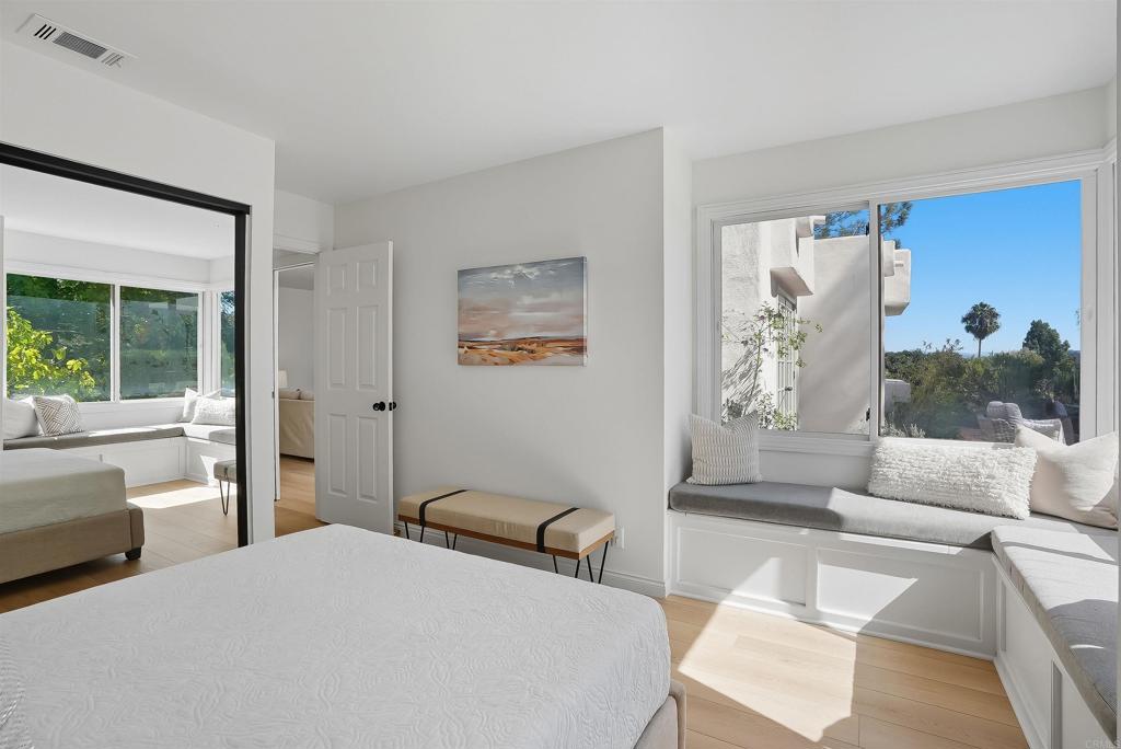 2206 Running Spring Place Encinitas, CA 92024 - Photo 30 of 44 a bedroom with a bed and a couch