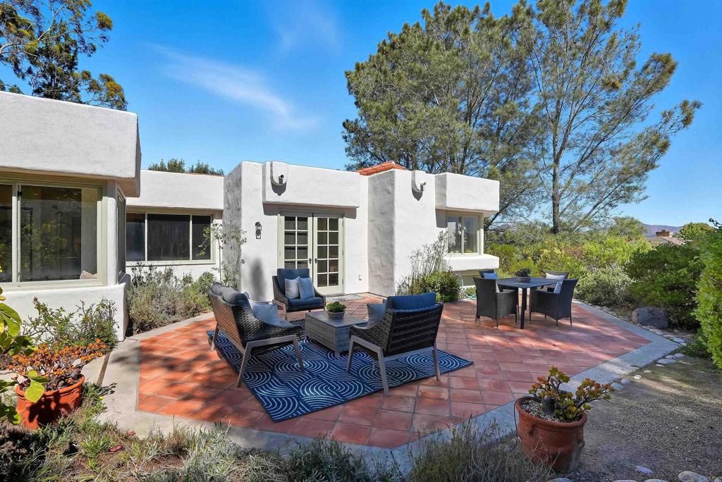 2206 Running Spring Place Encinitas, CA 92024 - Photo 3 of 44 a view of a patio with couches table and chairs and potted plants