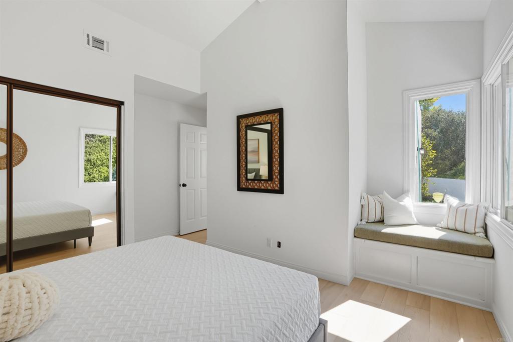 2206 Running Spring Place Encinitas, CA 92024 - Photo 35 of 44 a bedroom with a bed and a couch