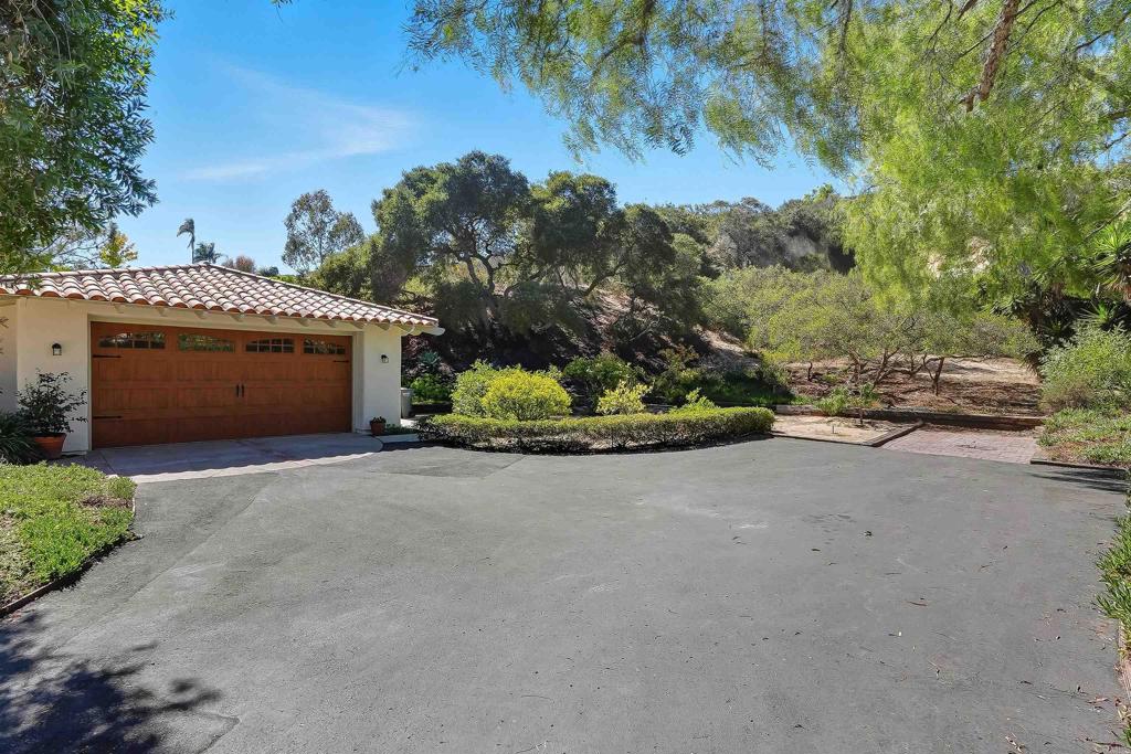 2206 Running Spring Place Encinitas, CA 92024 - Photo 7 of 44 a front view of a house with a yard and garage