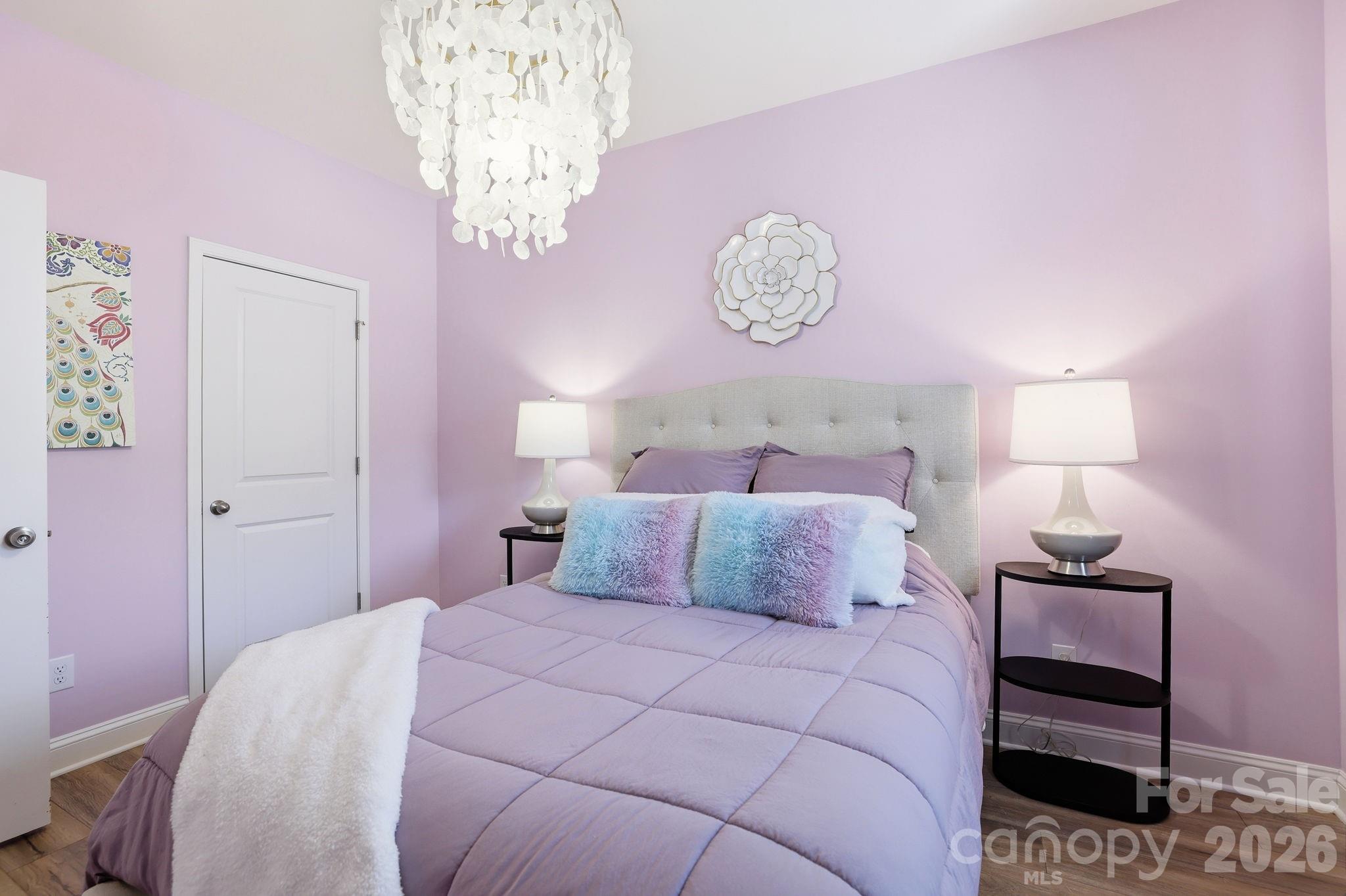 6038 Holland Street Fort Mill, SC 29707 - Photo 29 of 48 a bedroom with a bed and a chandelier