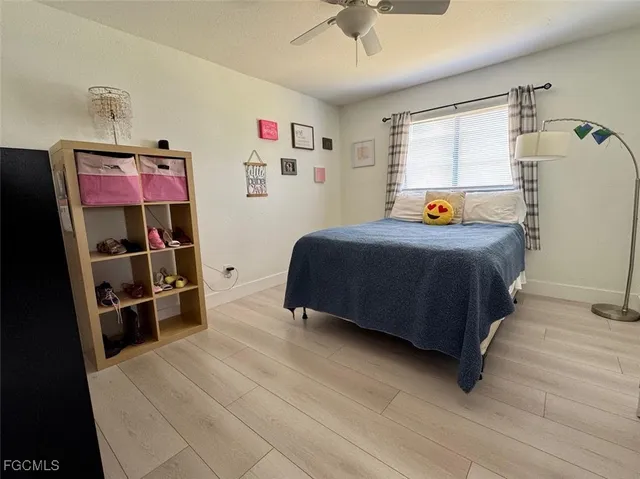 a bedroom with a bed closet and a window