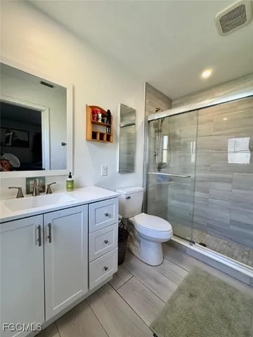 a bathroom with a toilet sink a shower and