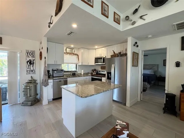 a kitchen with refrigerator and cabinets