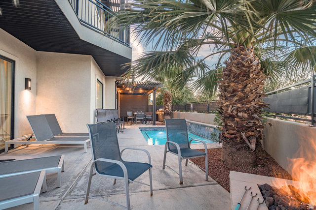 2600 Ocotillo Way, Unit 31 Santa Clara, UT 84765 - Photo 38 of 73 Outdoor living space featuring a private pool with water features, a built-in fire pit, a covered patio with a dining area, a second-story balcony, and mature palm trees