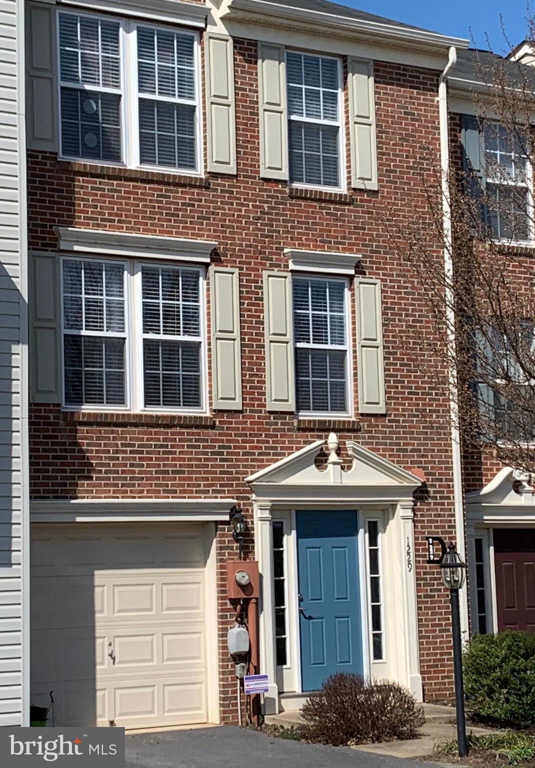 FRONT OF THE TOWNHOUSE. ONE-CAR GARAGE