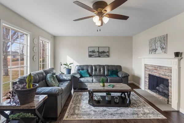 a living room with furniture a rug and a fireplace