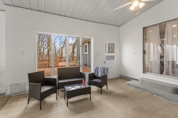 a living room with furniture and a floor to ceiling window