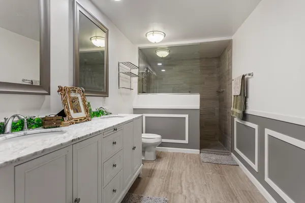 a spacious bathroom with a toilet sink and mirror