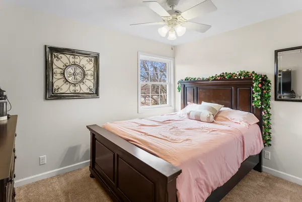 a bedroom with a bed and a chandelier