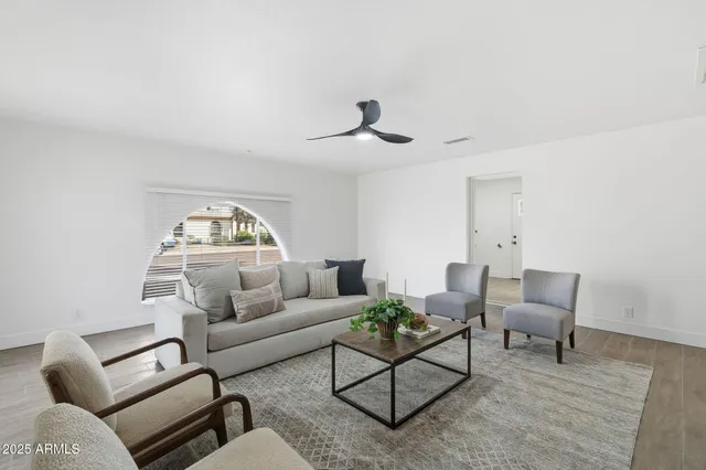 a living room with furniture and a wooden floor