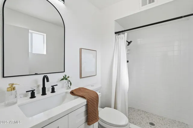a view of a room with a ceiling fan