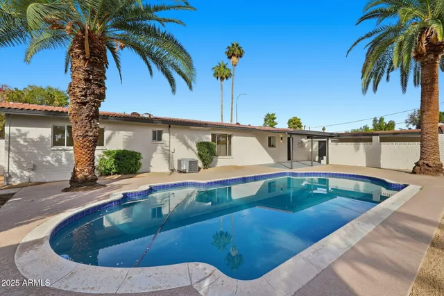 a view of a swimming pool with a yard