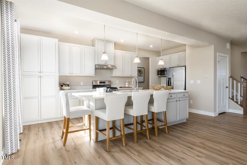 548 Impala Trace Wendell, NC 27591 - Photo 2 of 10 a large kitchen with a table and chairs