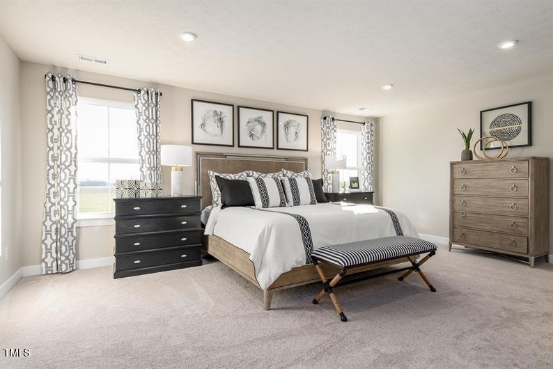 548 Impala Trace Wendell, NC 27591 - Photo 6 of 10 a bedroom with a bed and a dresser