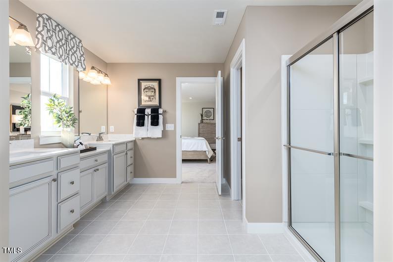 548 Impala Trace Wendell, NC 27591 - Photo 8 of 10 a bathroom with a double vanity sink and mirror