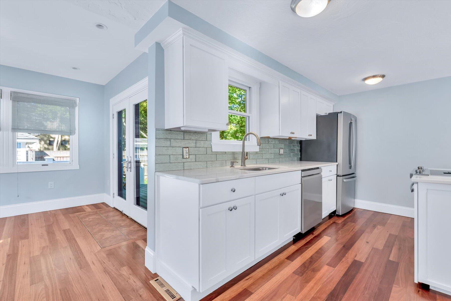 22 Bay View Avenue Buzzards Bay, MA 02532 - Photo 11 of 42 a kitchen with white cabinets and wooden floor