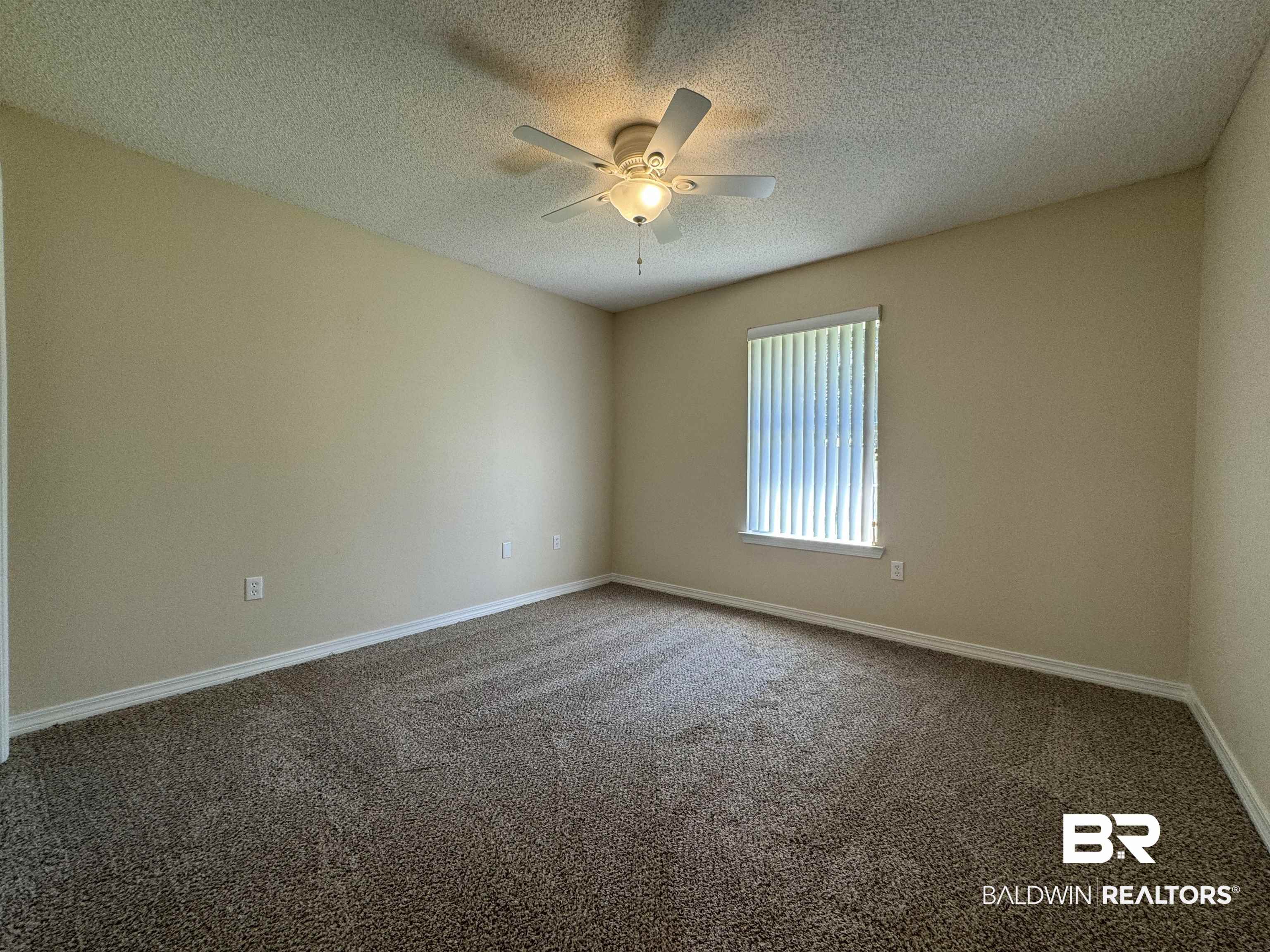 32769 Arbor Ridge Circle Lillian, AL 36549 - Photo 21 of 36 Carpeted spare room with ceiling fan and a textured ceiling
