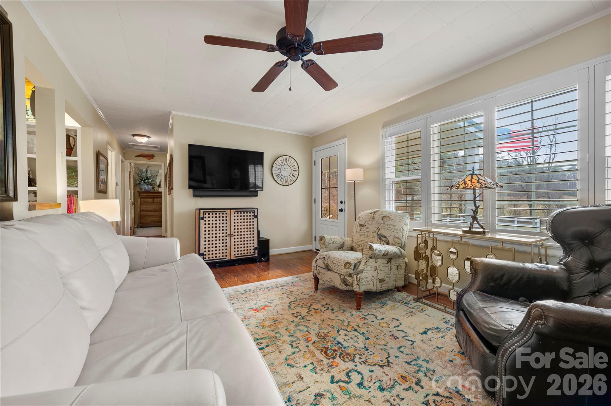 514 Roy Forrester Road Mars Hill, NC 28754 - Photo 7 of 25 a living room with furniture ceiling fan and a flat screen tv