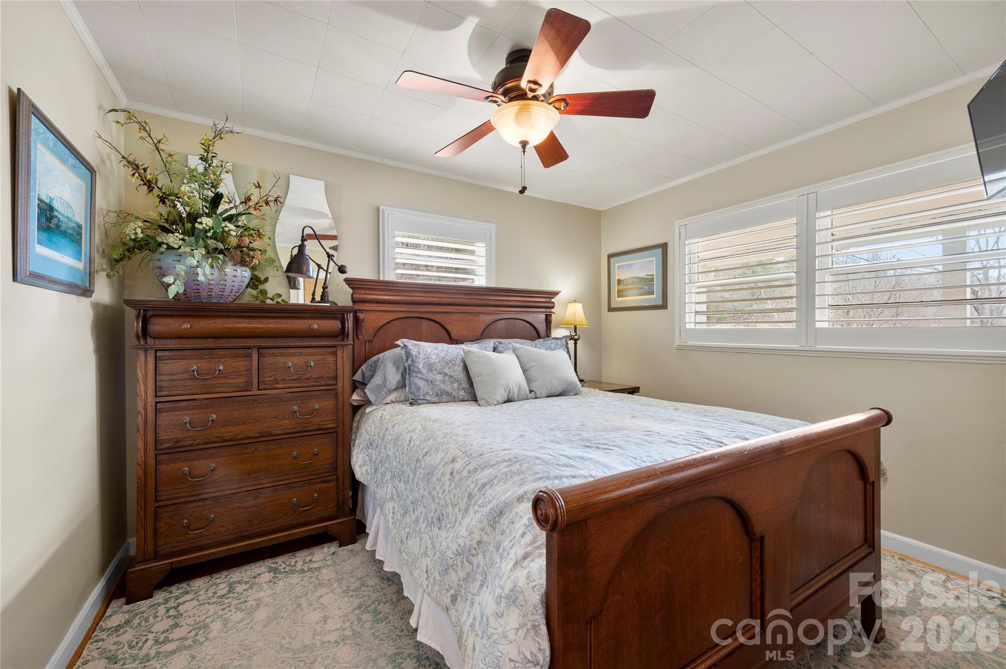 514 Roy Forrester Road Mars Hill, NC 28754 - Photo 10 of 25 a bedroom with a bed and a chandelier