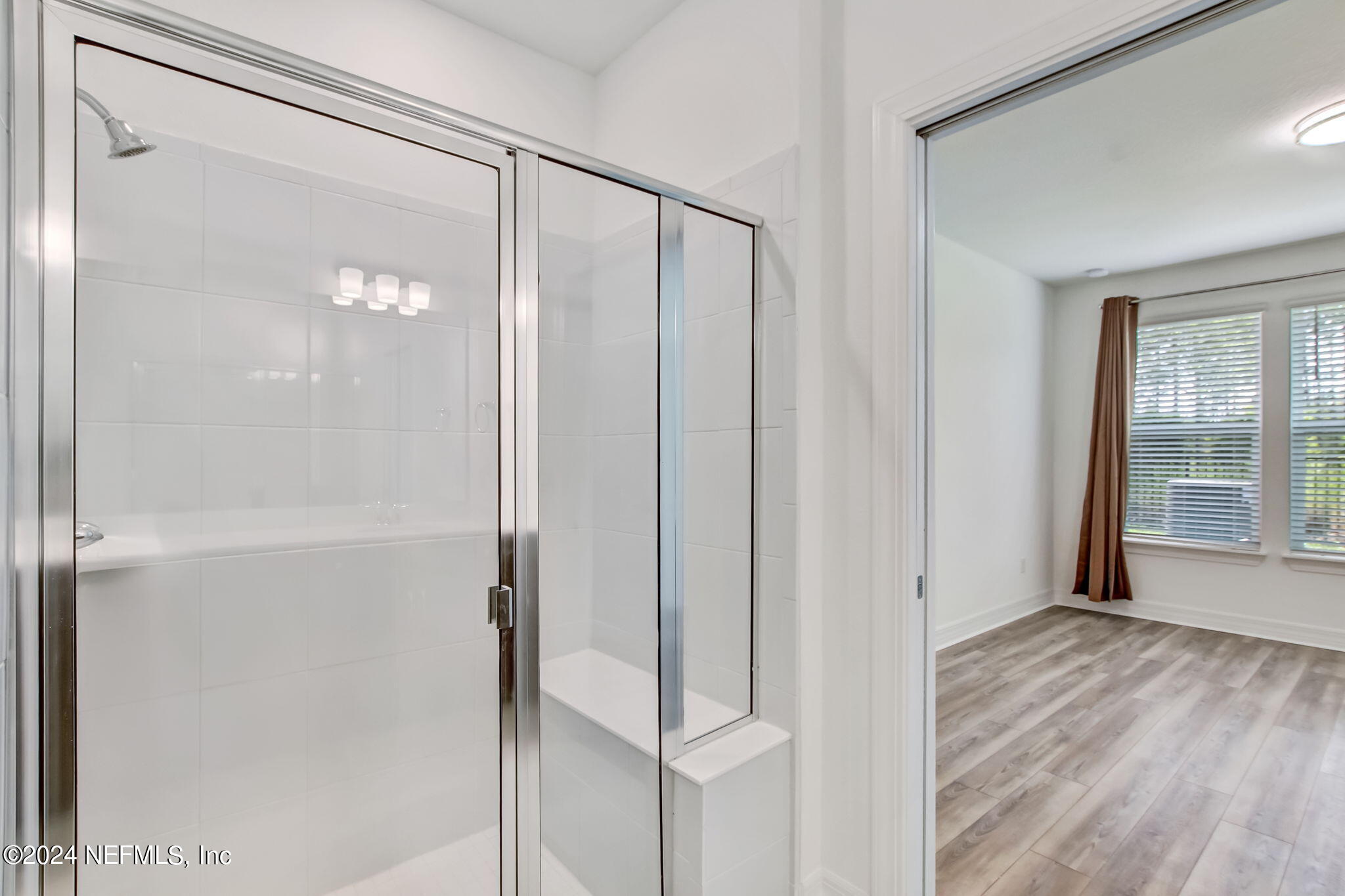 524 Jubilee Circle Yulee, FL 32097 - Photo 13 of 25 a bathroom with a glass shower door