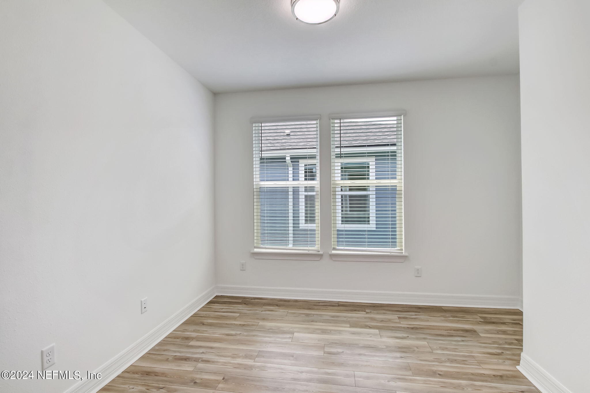 524 Jubilee Circle Yulee, FL 32097 - Photo 22 of 25 an empty room with wooden floor and windows