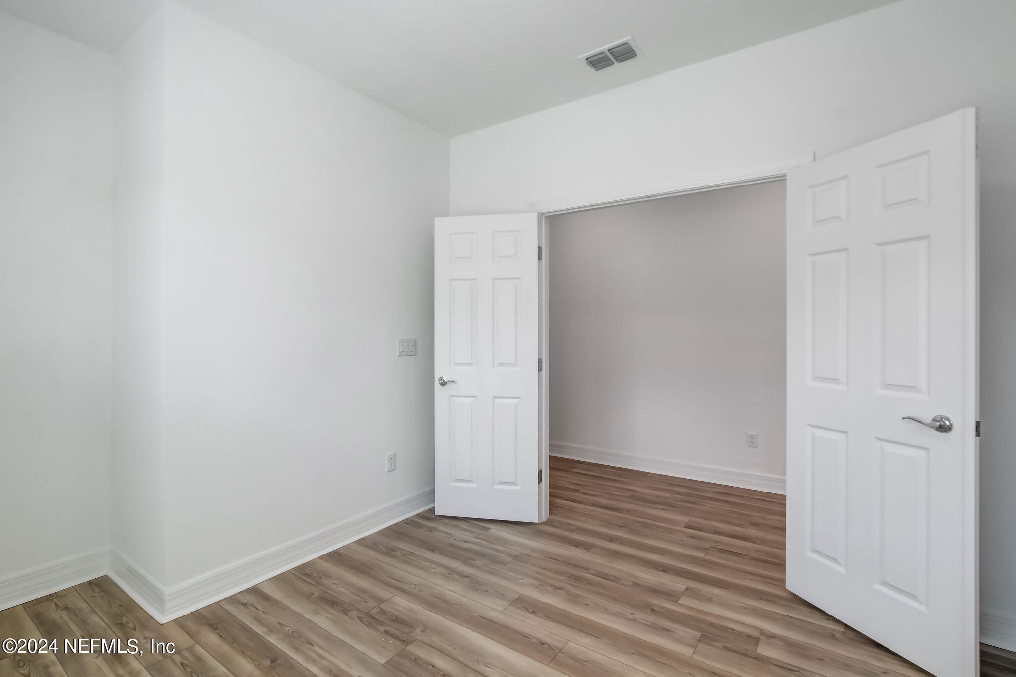 524 Jubilee Circle Yulee, FL 32097 - Photo 23 of 25 a view of an empty room with wooden floor