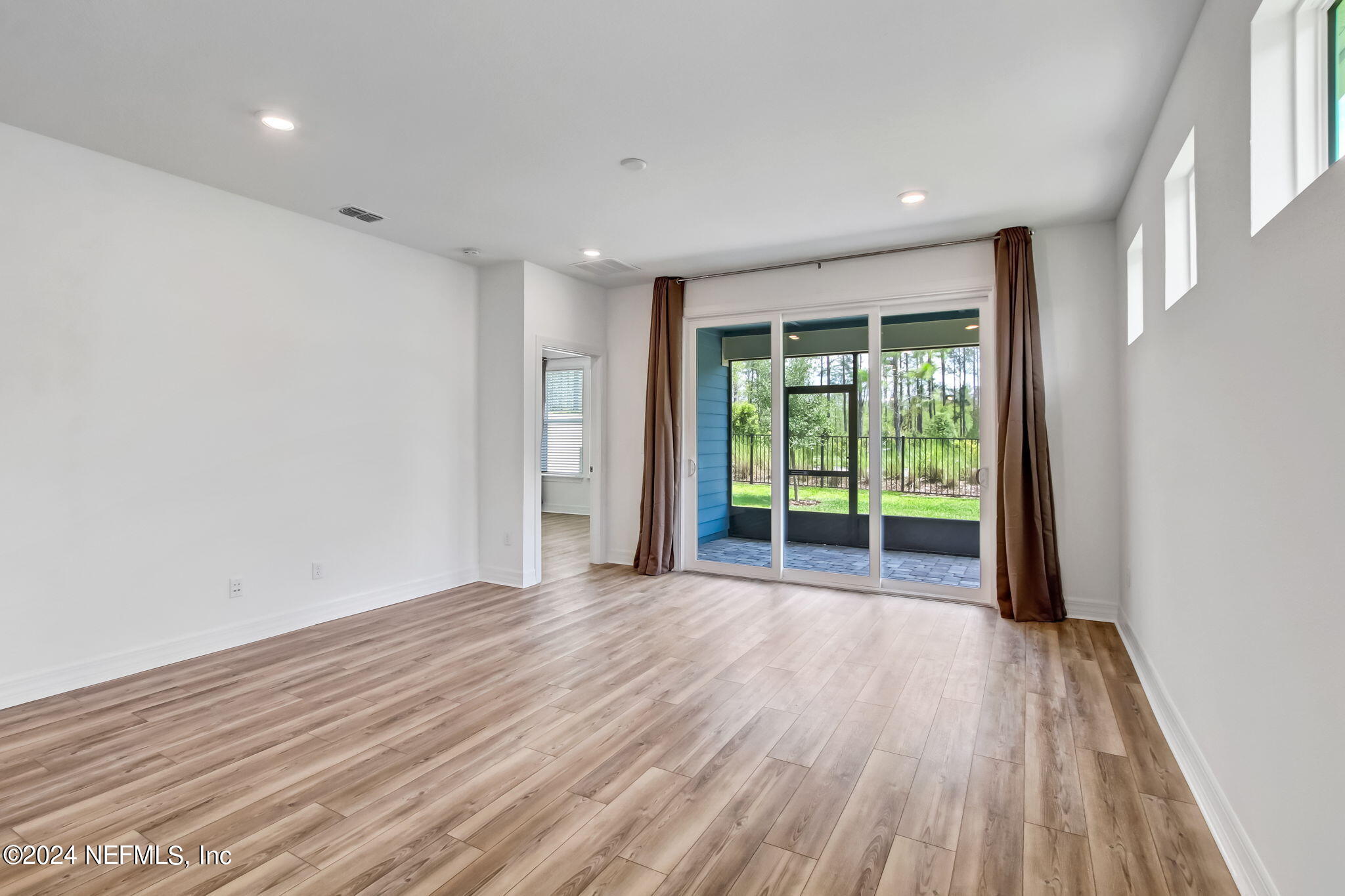 524 Jubilee Circle Yulee, FL 32097 - Photo 25 of 25 a view of an empty room with wooden floor and a window