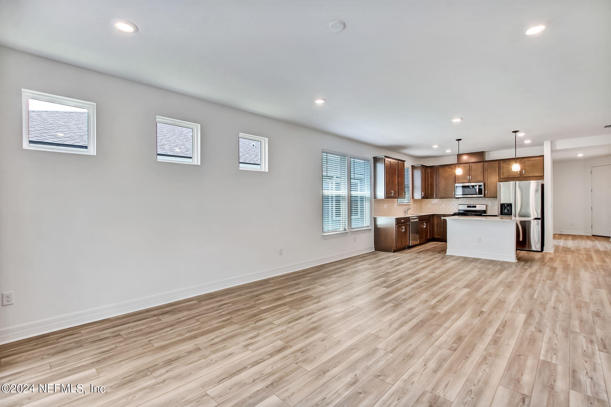 524 Jubilee Circle Yulee, FL 32097 - Photo 9 of 25 a view of kitchen with wooden floor and electronic appliances