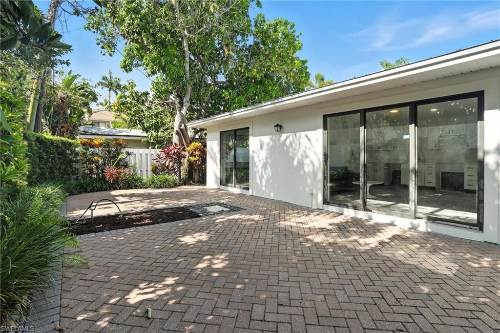 721 9th Street South, Unit 4 Naples, FL 34102 - Photo 3 of 8 a view of a house with a yard