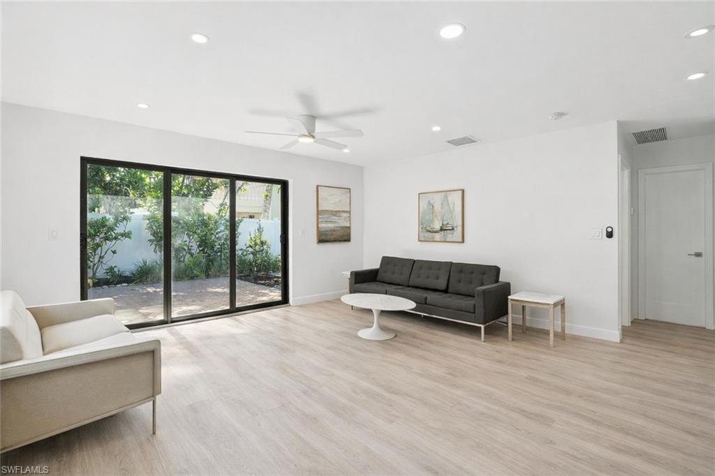 721 9th Street South, Unit 4 Naples, FL 34102 - Photo 5 of 8 a living room with furniture and a large window