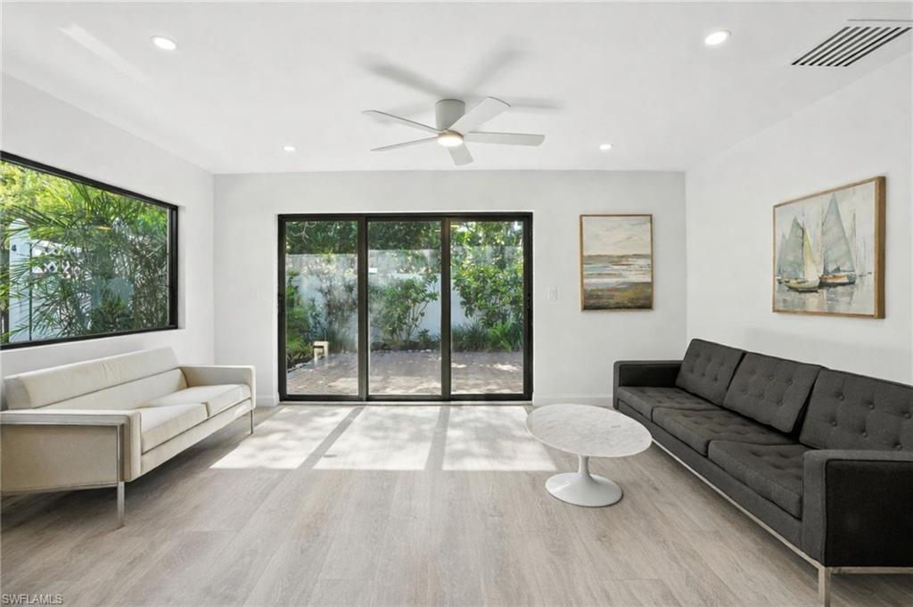 721 9th Street South, Unit 4 Naples, FL 34102 - Photo 6 of 8 a living room with furniture and a large window