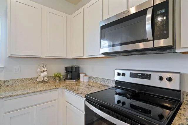 a kitchen with a stove a table and chairs