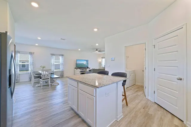 a kitchen with stainless steel appliances granite countertop a sink dishwasher stove and refrigerator