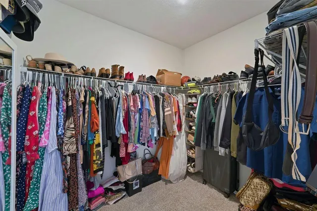 a en suite bathroom with a granite countertop sink and a mirror
