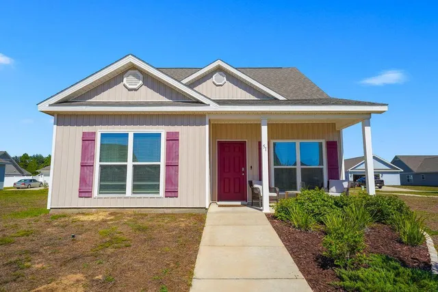 a front view of a house with garden
