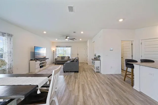 a large white kitchen with a large window