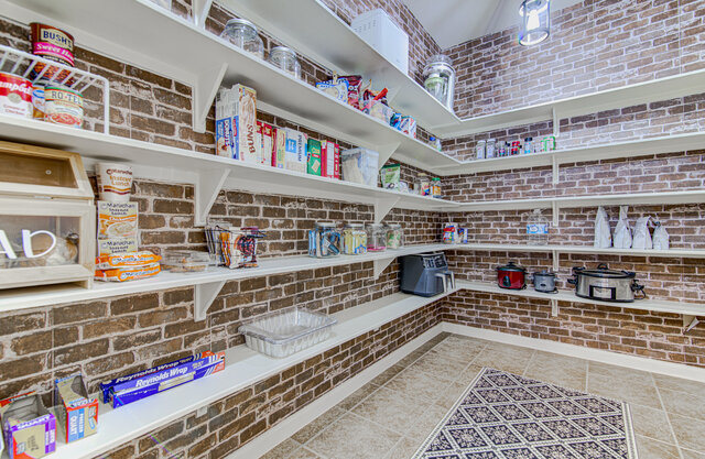 507 Rummel Ranch Run Cedar Park, TX 78613 - Photo 24 of 39 Organized shelving and charming brick-patterned walls define this functional and stylish pantry.