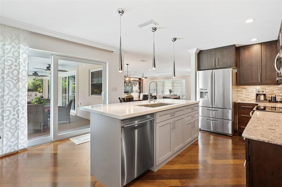 807 Berkley Street Boca Raton, FL 33487 - Photo 12 of 34 a kitchen with kitchen island a counter top space stainless steel appliances and cabinets