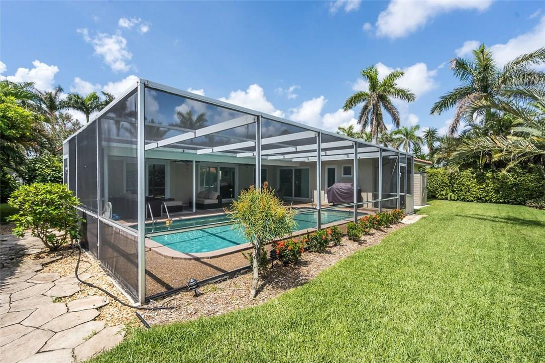 807 Berkley Street Boca Raton, FL 33487 - Photo 25 of 34 a view of house with a big yard and potted plants