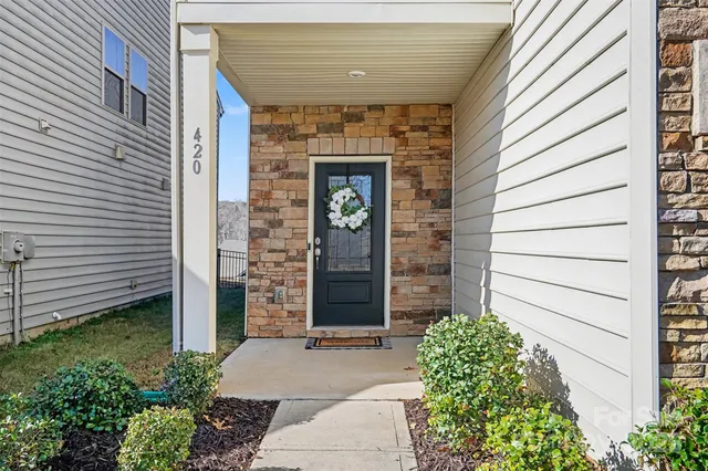 a front view of a house with potted plants