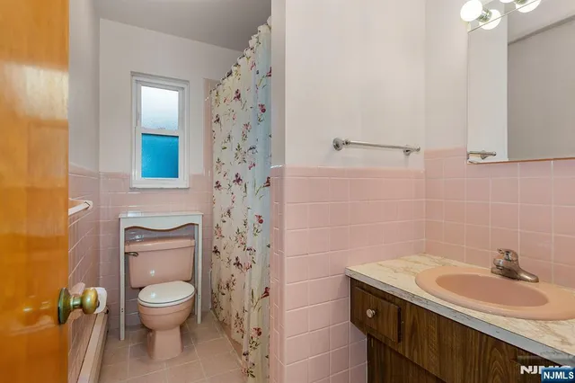 a bathroom with a granite countertop toilet a sink and a shower