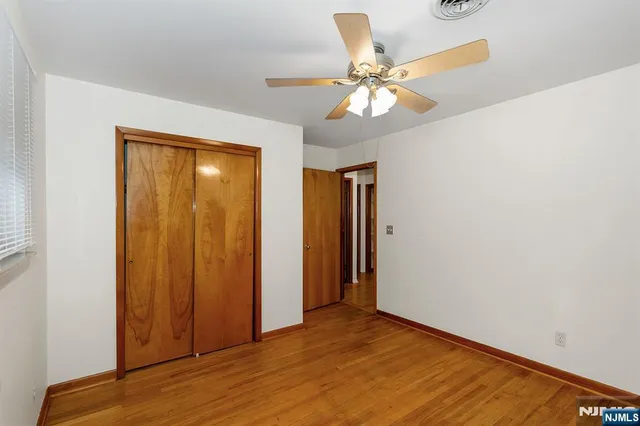 a view of an empty room with a fan