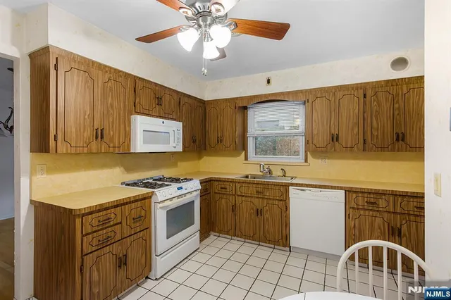a kitchen with a stove sink and cabinets