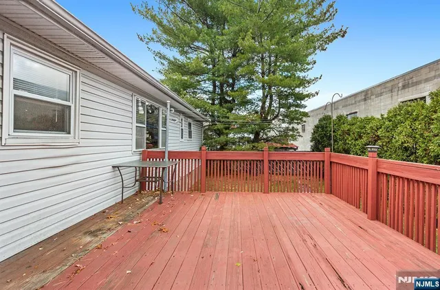a view of balcony with wooden floor and fence