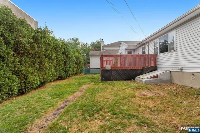 a view of a house with a yard and sitting area
