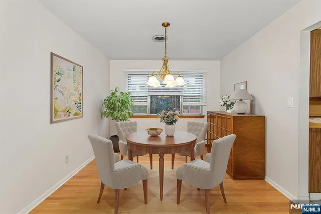a dining room with furniture a window and a chandelier